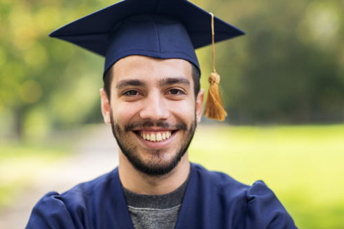 close up of student or bachelor in mortar board 500x333